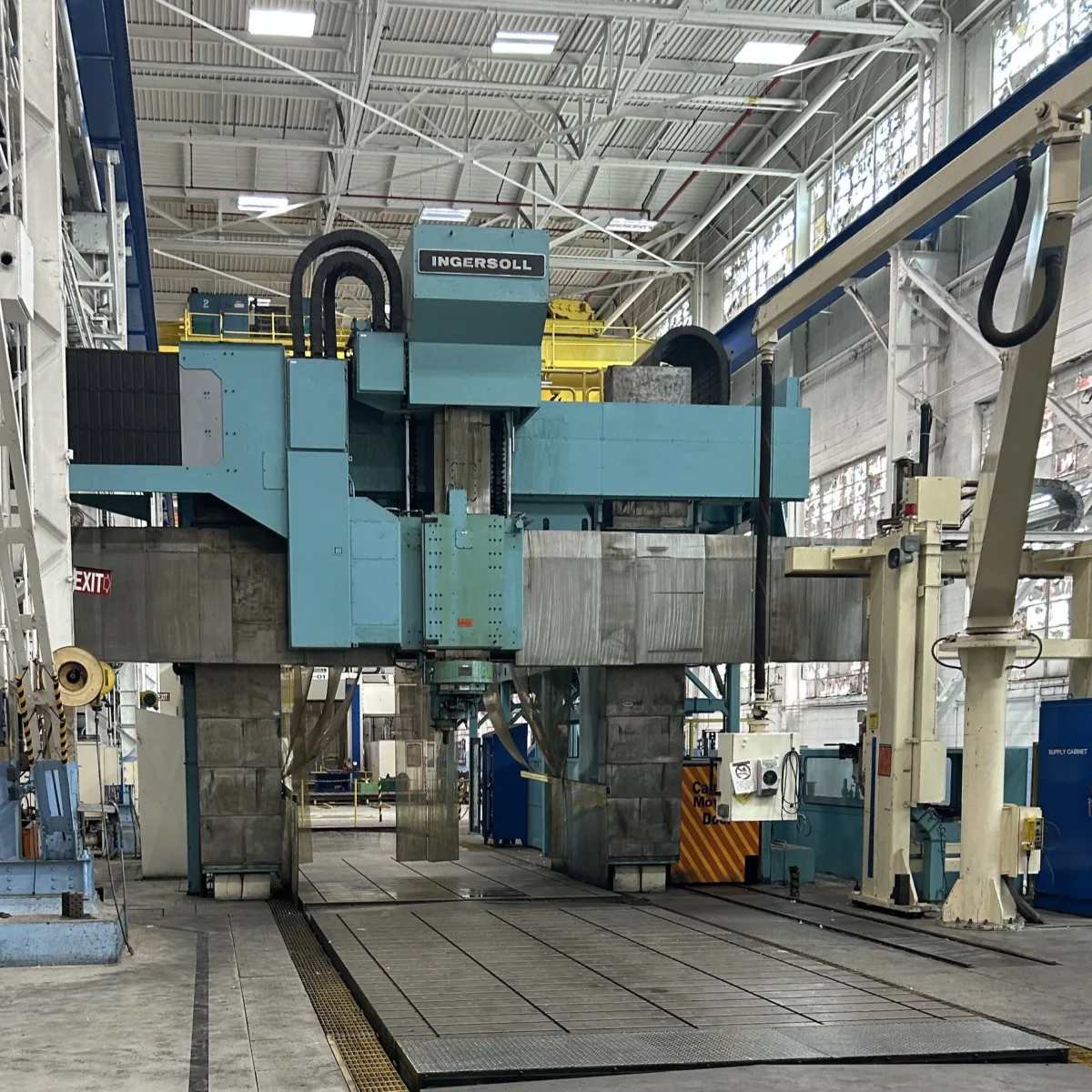 Automated gantry loading system over a CNC machining line, documented during a machinery appraisal