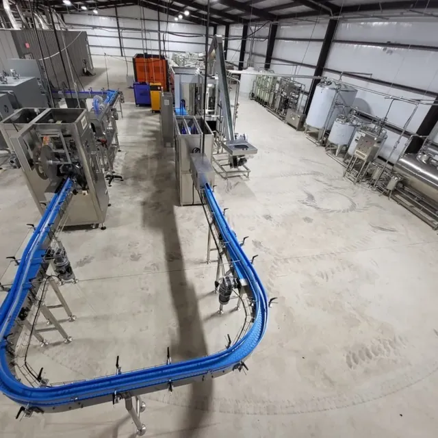 Bottling line with conveyors, filler, labeler and stainless process tanks