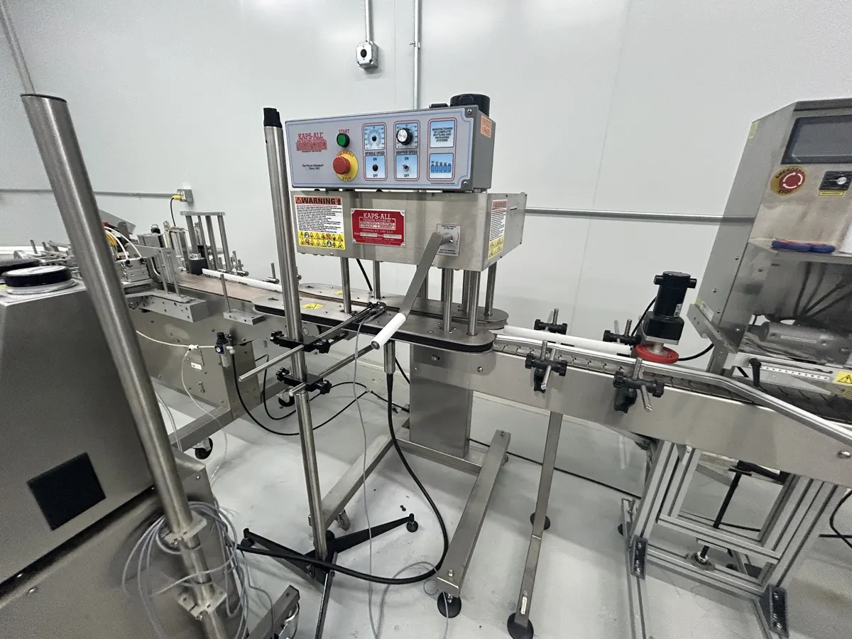 Bottle filling and capping line documented during a packaging equipment appraisal