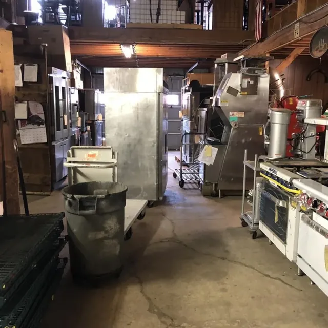 Used commercial ranges, mixers and refrigeration in a restaurant equipment warehouse