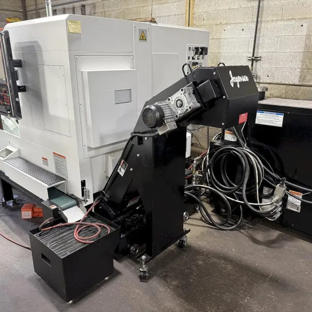 CNC turning center with a chip conveyor