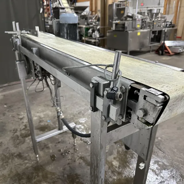 Stainless steel belt conveyor in a food equipment warehouse