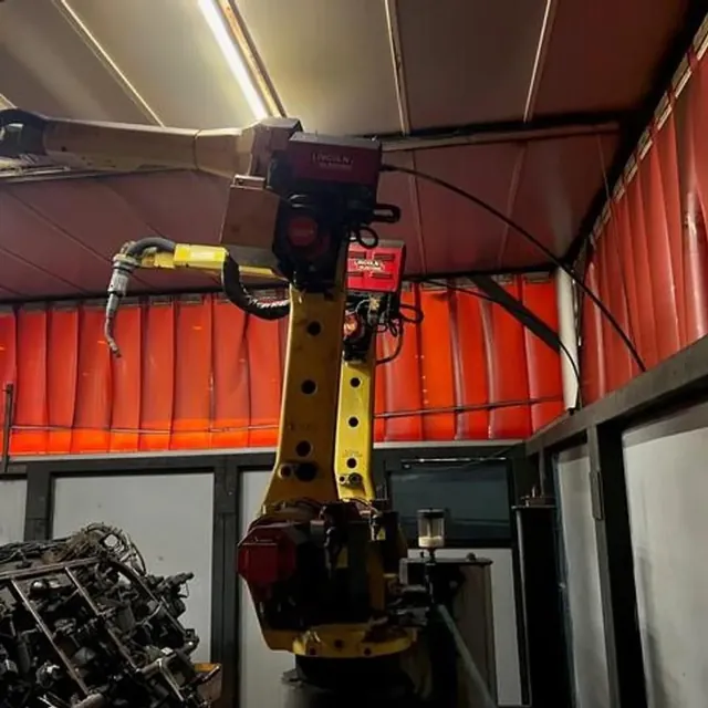 FANUC welding robot with Lincoln Electric wire feeders in a welding cell