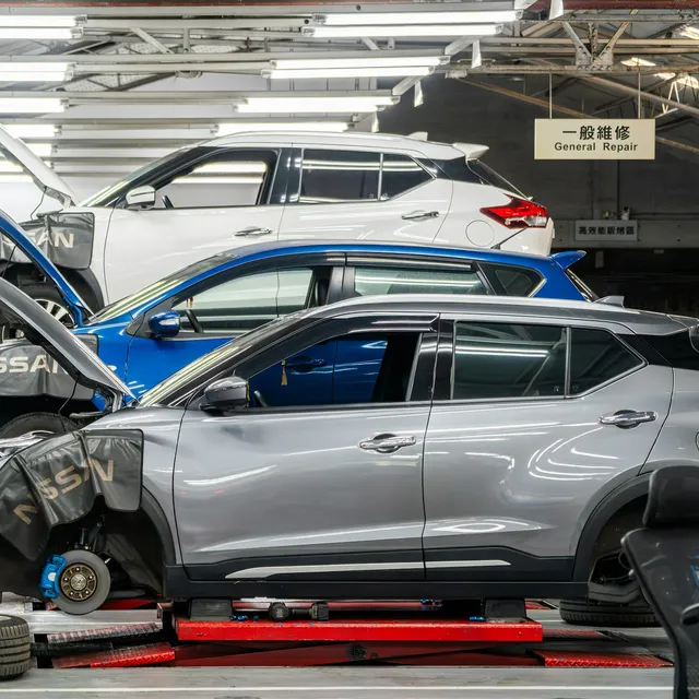 Vehicles on scissor lifts in a dealership service department