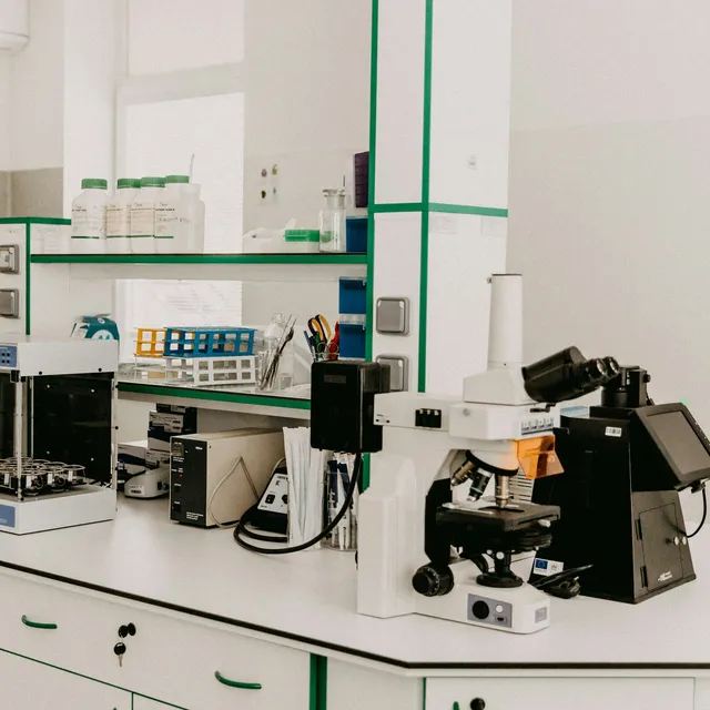 Laboratory bench with a research microscope and bench instruments