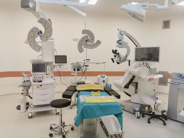 Operating room with surgical lights, anesthesia workstation, operating table and surgical microscope